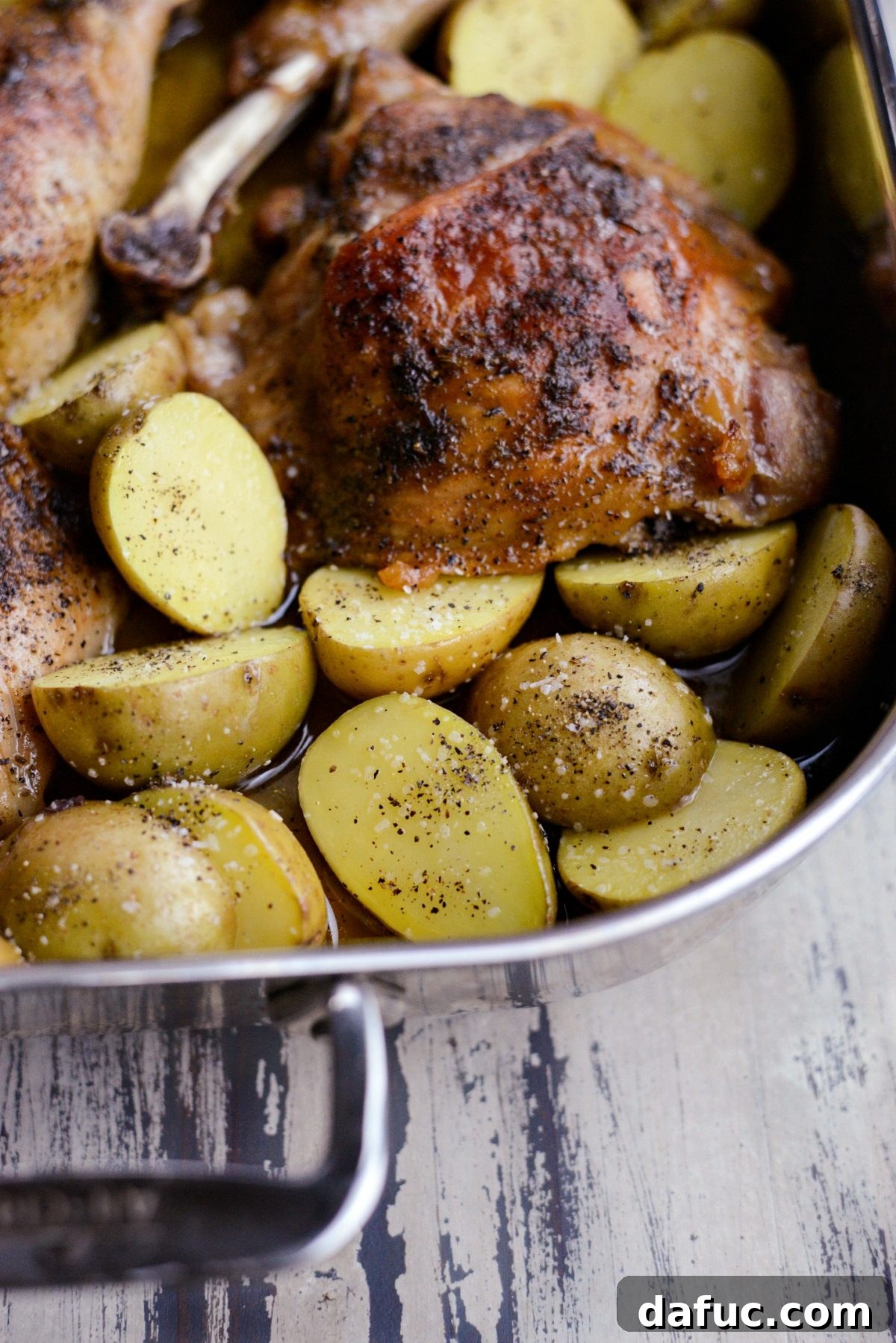 Seasoning potatoes with salt and pepper before further roasting for enhanced flavor