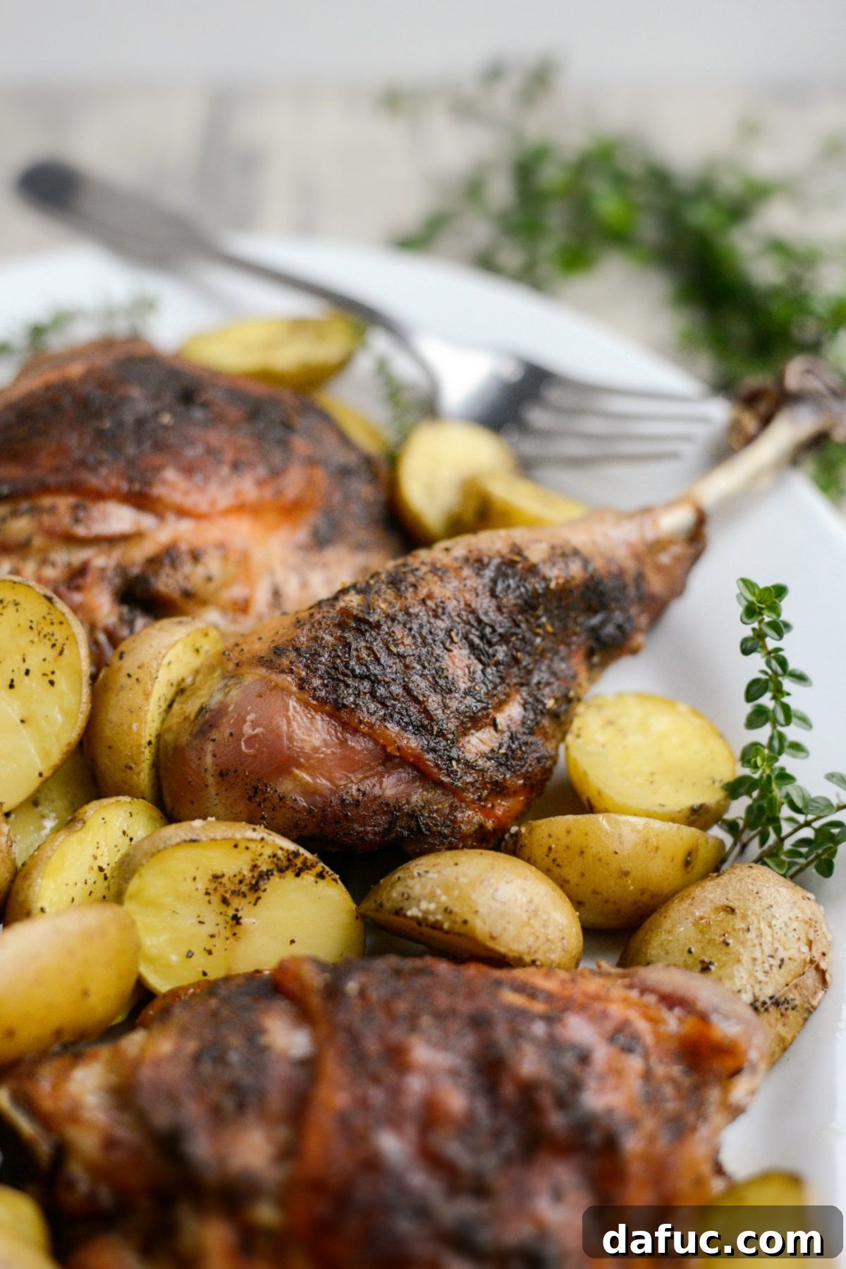 Detail shot of a perfectly roasted turkey drumstick, highlighting the golden-brown, crispy skin and juicy meat