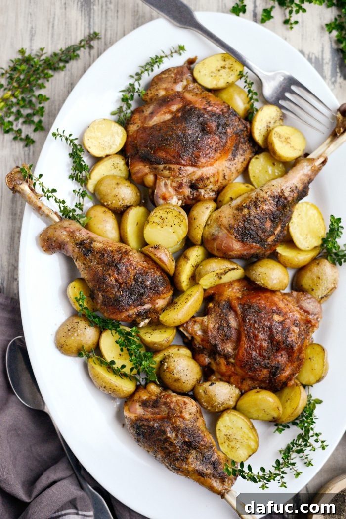Generous serving platter featuring beautifully roasted turkey thighs, drumsticks, and golden potatoes