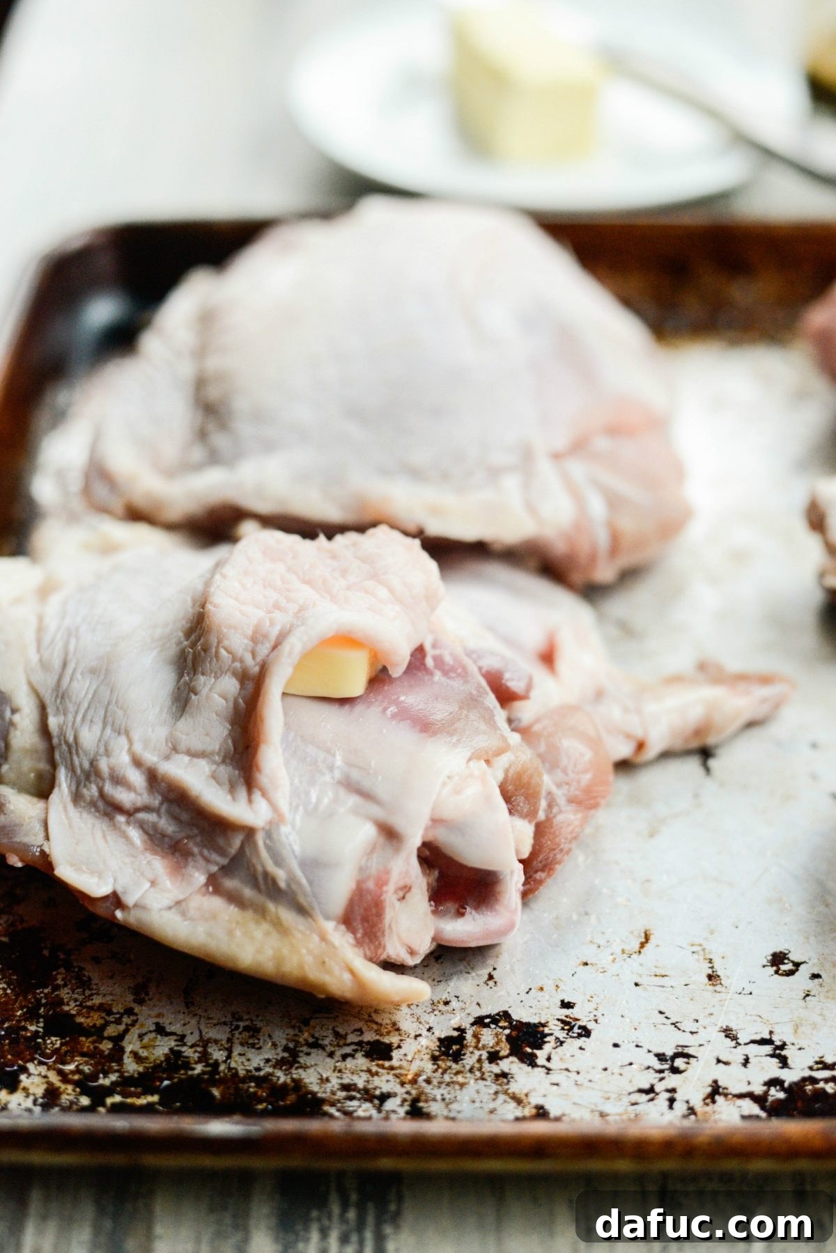 Expertly applying softened butter underneath the turkey skin for maximum flavor and moisture
