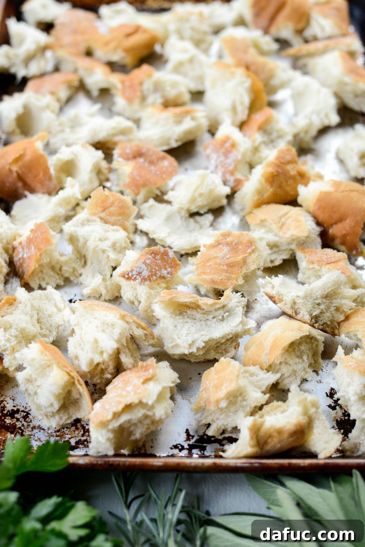 Artisan Herb Sourdough Dressing 5 torn sourdough on rimmed baking sheet