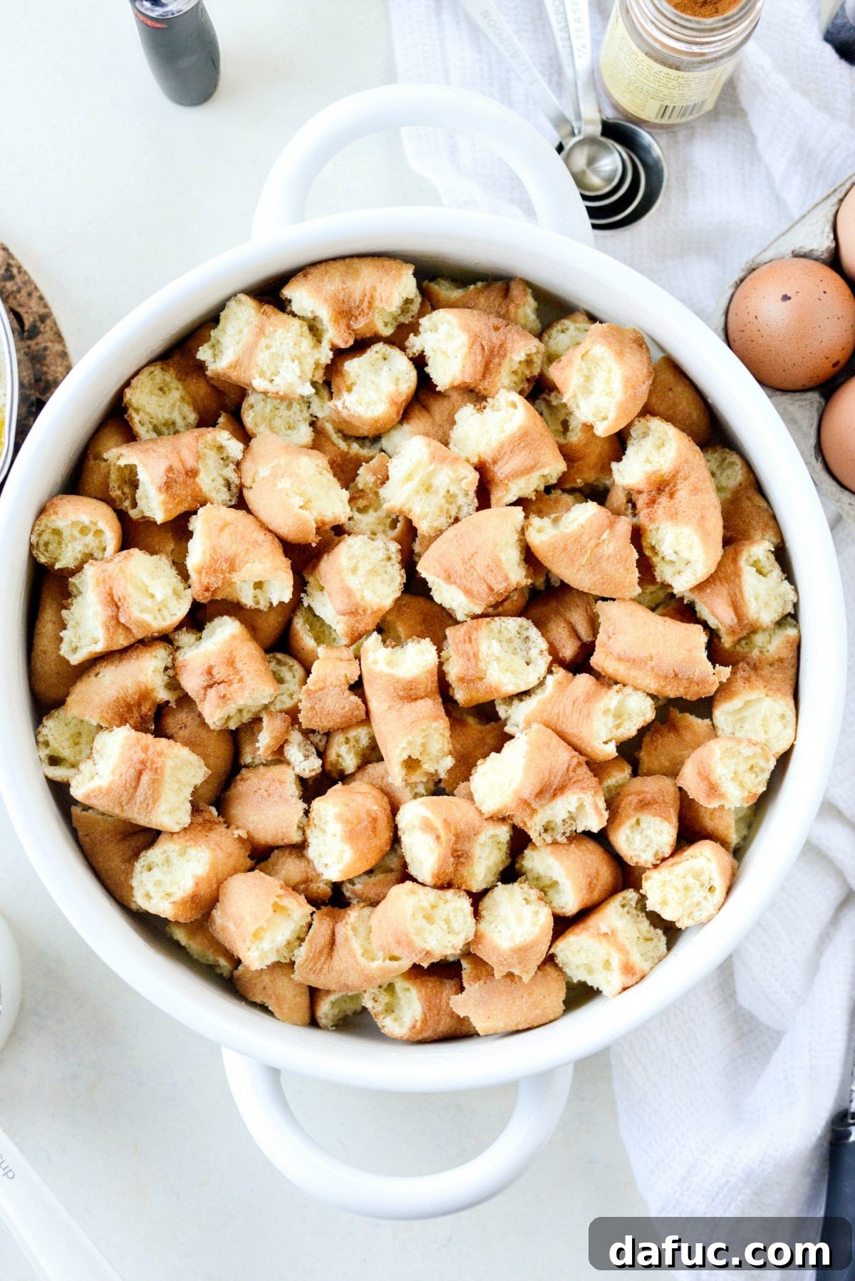 Autumn Spiced Doughnut Bread Pudding 6 Adding broken day-old cider mill doughnuts into a prepared baking dish