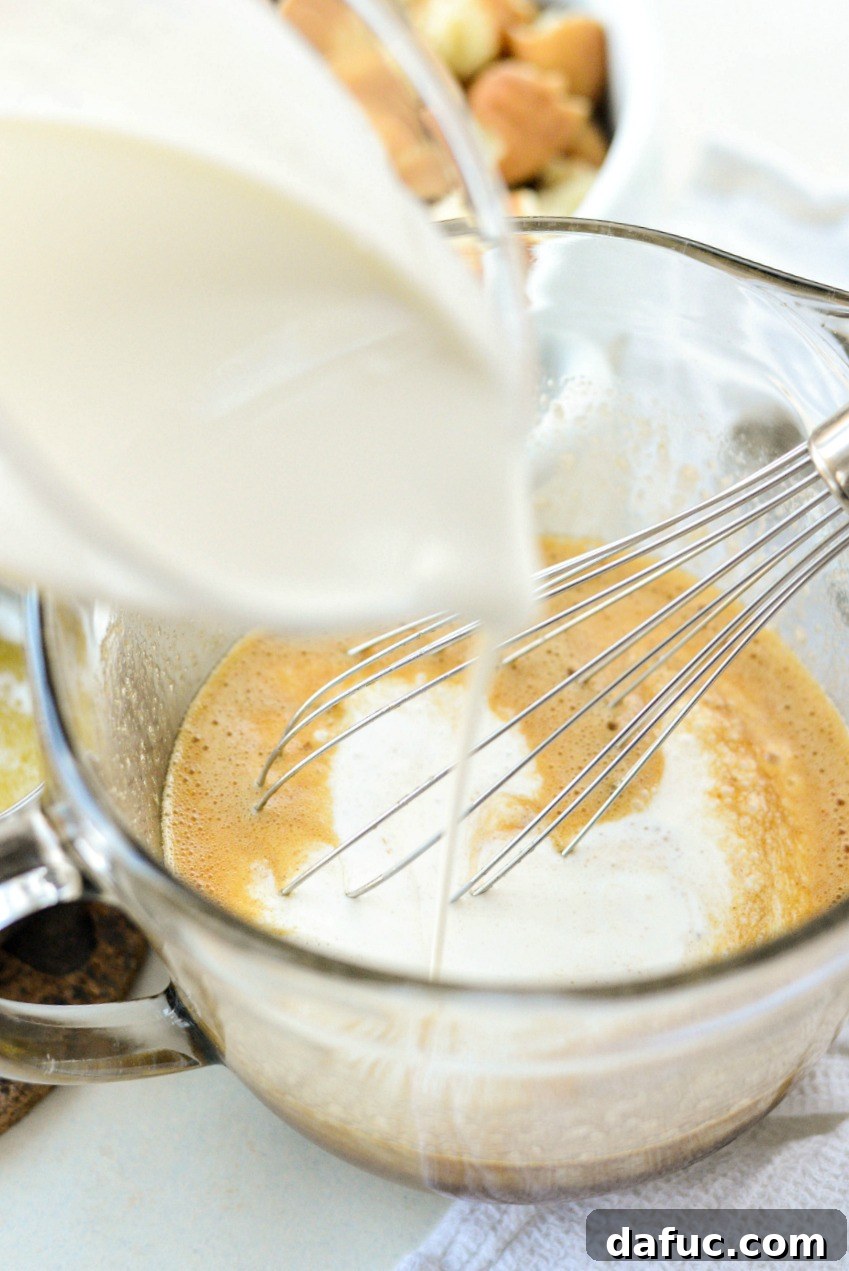 Autumn Spiced Doughnut Bread Pudding 10 Pouring two cups of heavy cream into the spiced egg and sugar mixture