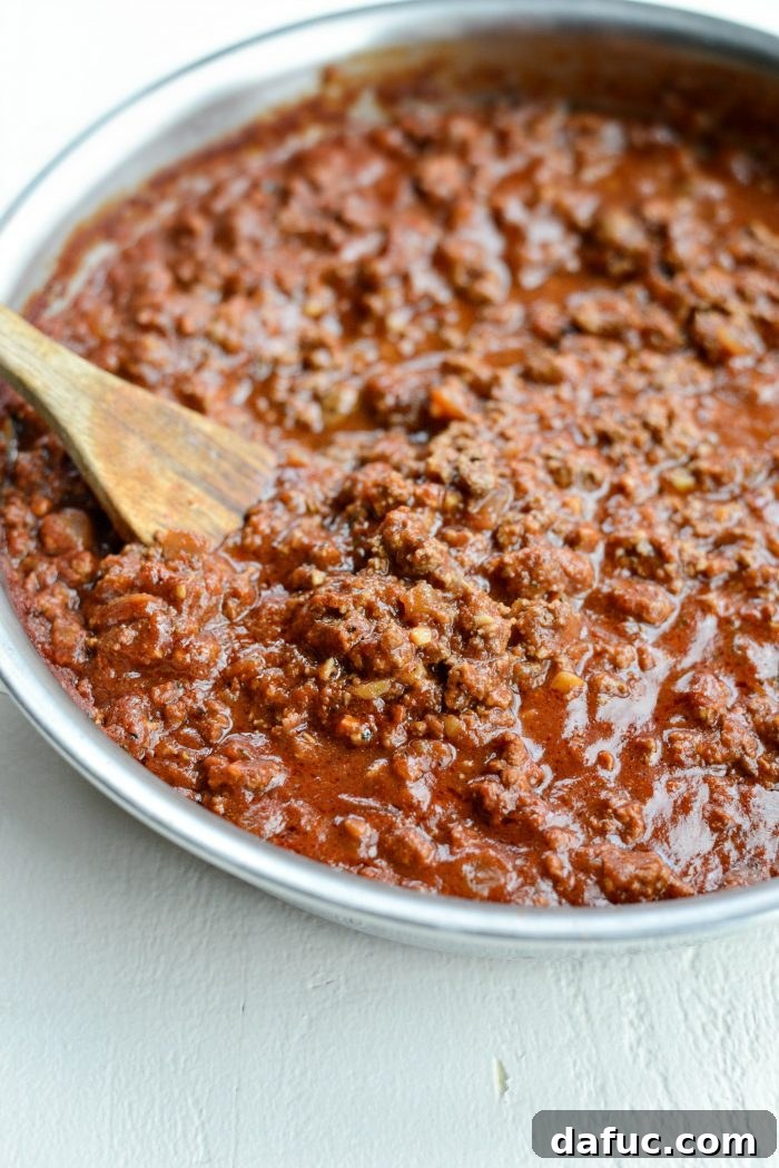 Best Basic Meat Sauce Recipe served with grated Parmesan and fresh herbs
