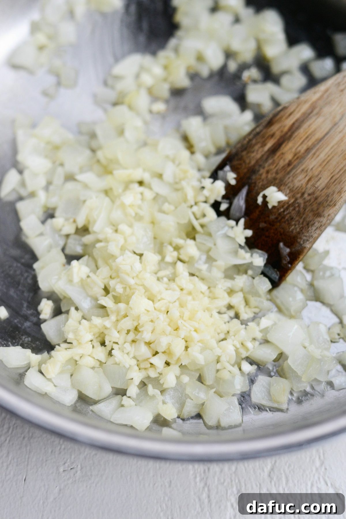 Onions softening in a skillet on medium-low heat