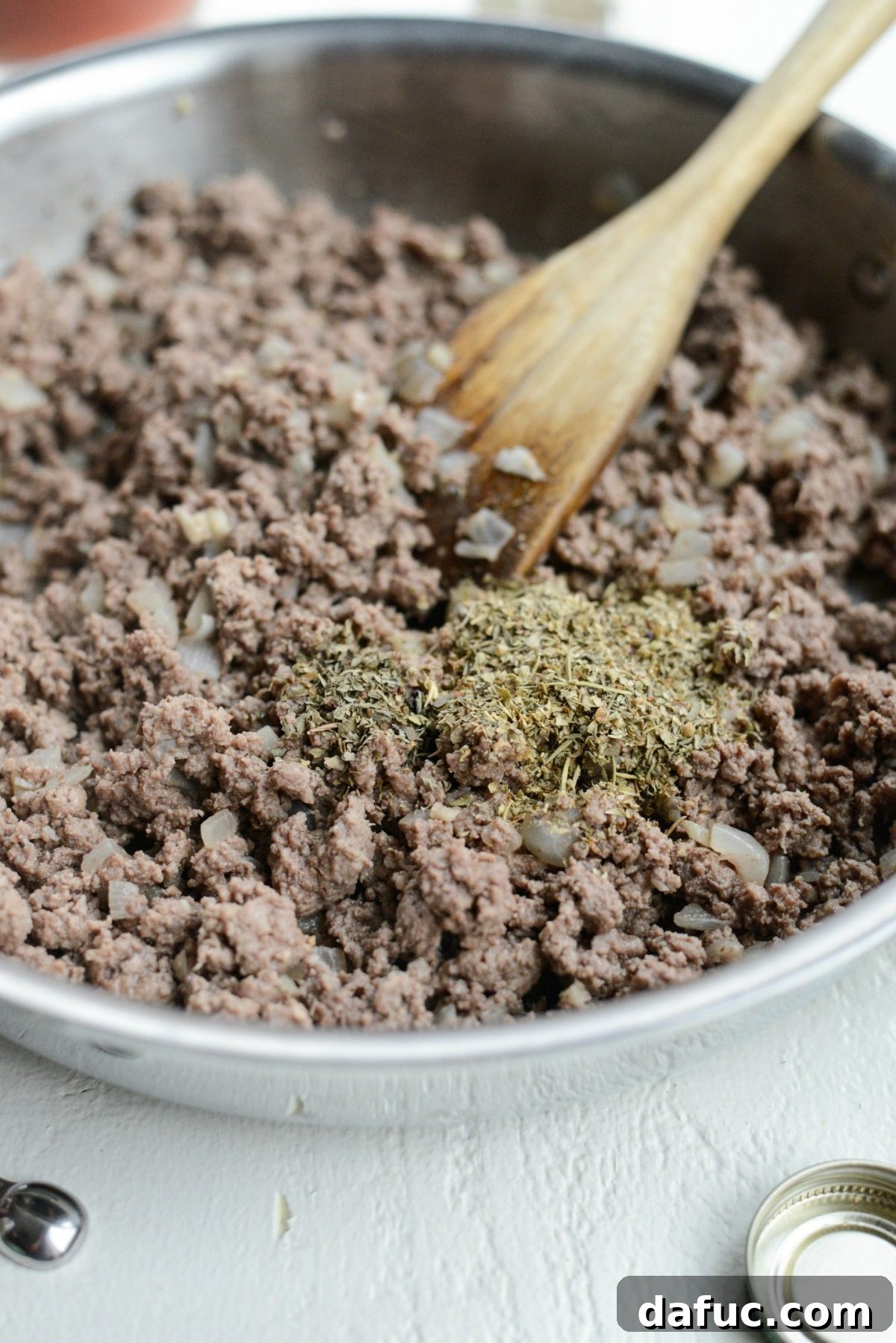 Meat sauce ingredients combining in a skillet