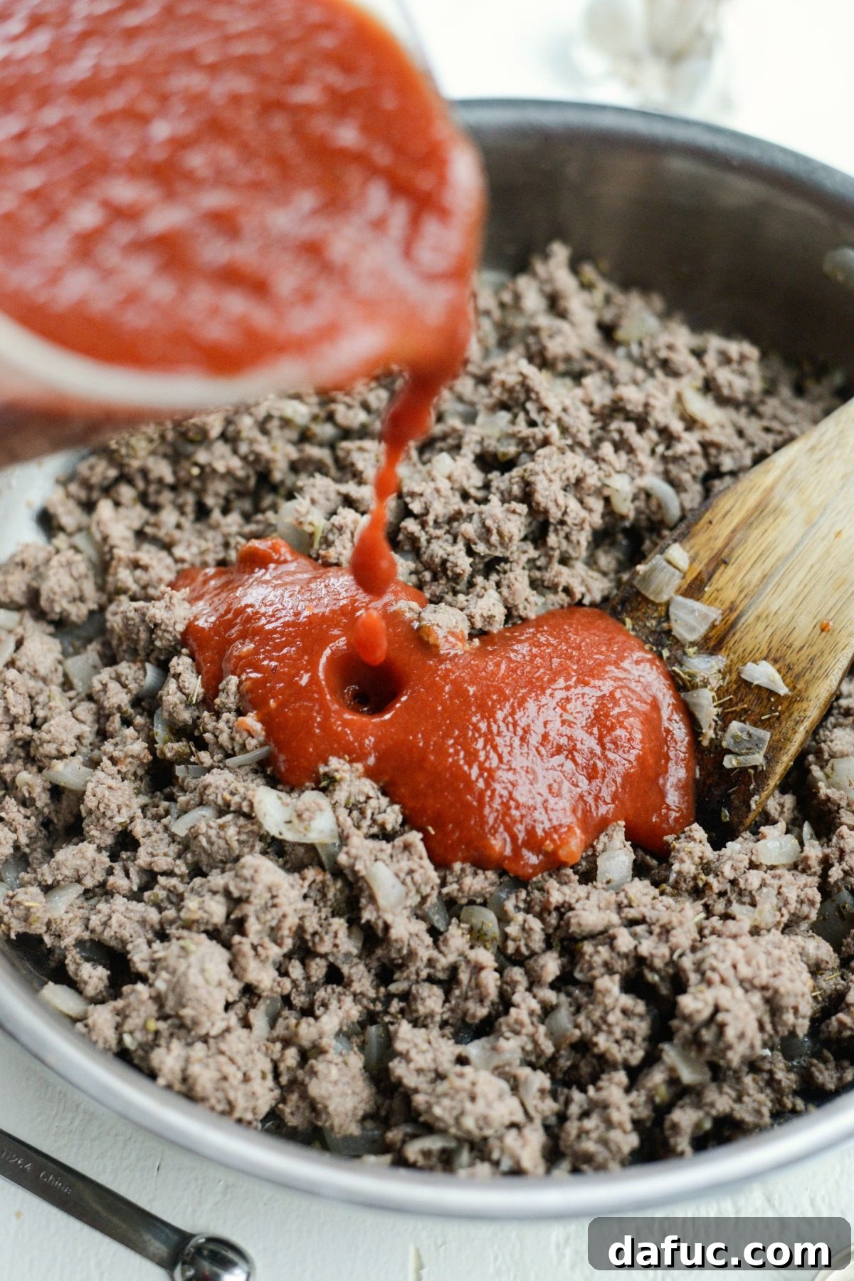 Cooked ground beef with spices, ready for tomato sauce