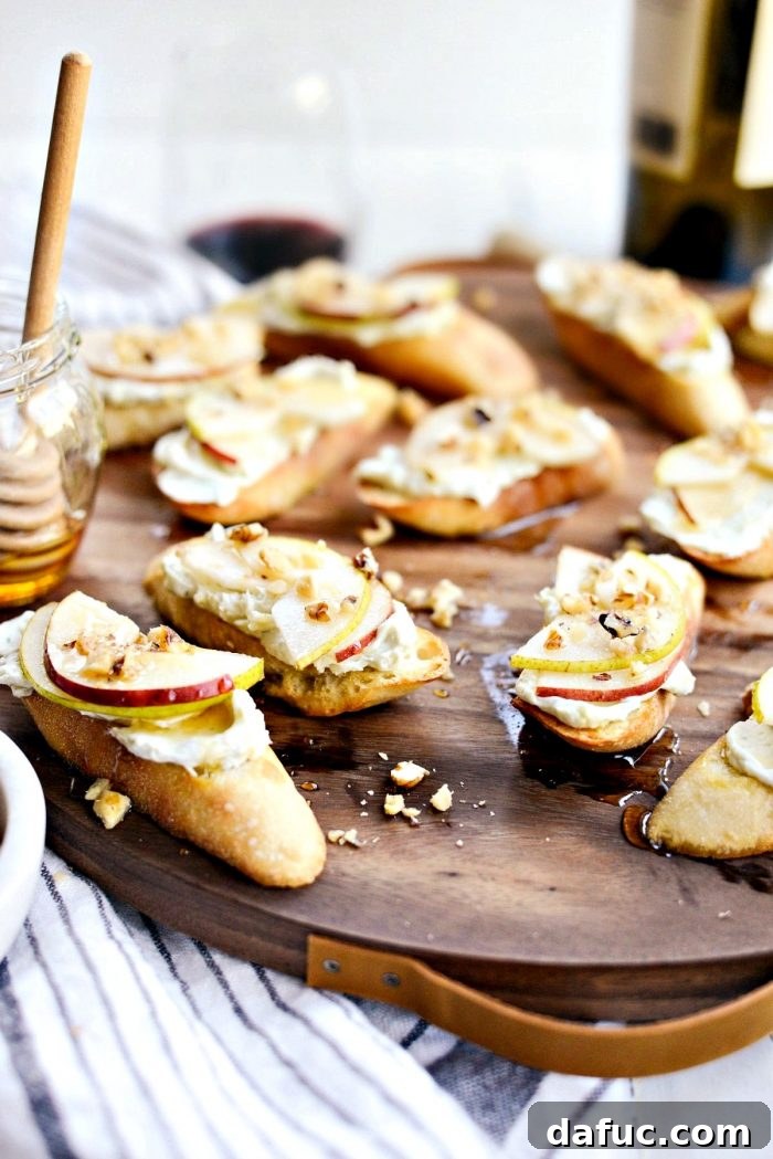 A beautifully presented serving board filled with freshly made Whipped Blue Cheese Crostini, ready for guests to enjoy at a gathering.
