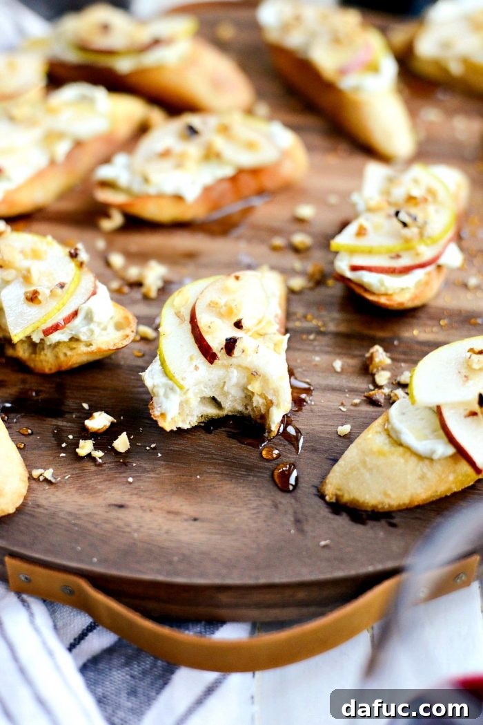 Final close-up of a single Whipped Blue Cheese Crostini with pear, honey, and walnuts, highlighting its appetizing appeal and texture.