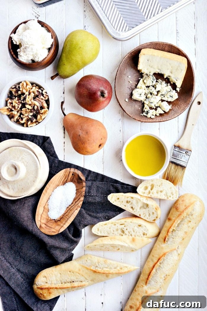 Overhead shot of a platter of Whipped Blue Cheese Crostini with various pear types, ready to be served as an elegant party appetizer.