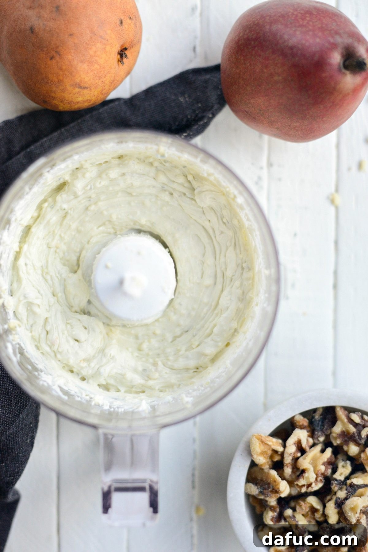 Whipping cream cheese and crumbled blue cheese together in a mini food processor for the crostini spread.