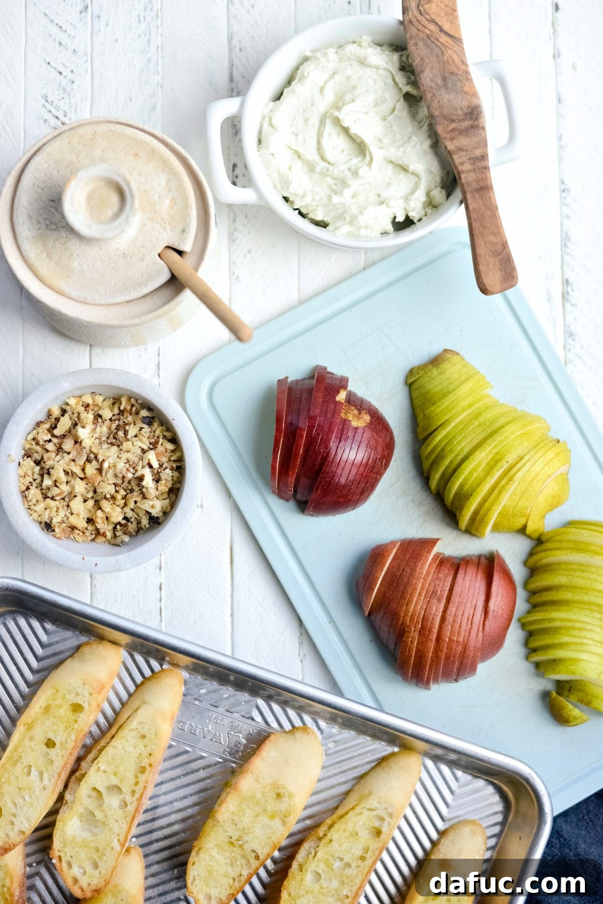 Step-by-step assembly of Whipped Blue Cheese Crostini, showing the spread cheese and placement of pear slices.