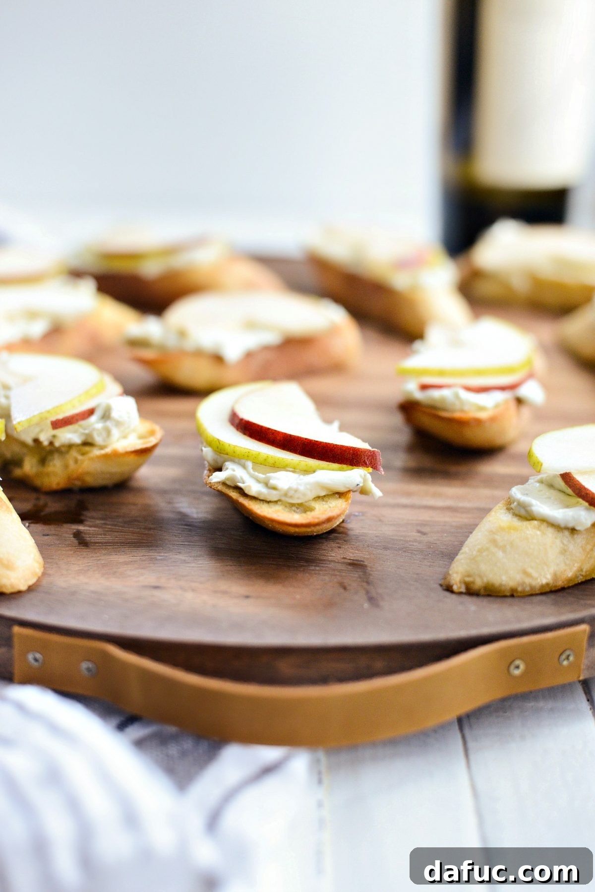 Topping toasted baguette with creamy whipped blue cheese and thinly sliced fresh pear.