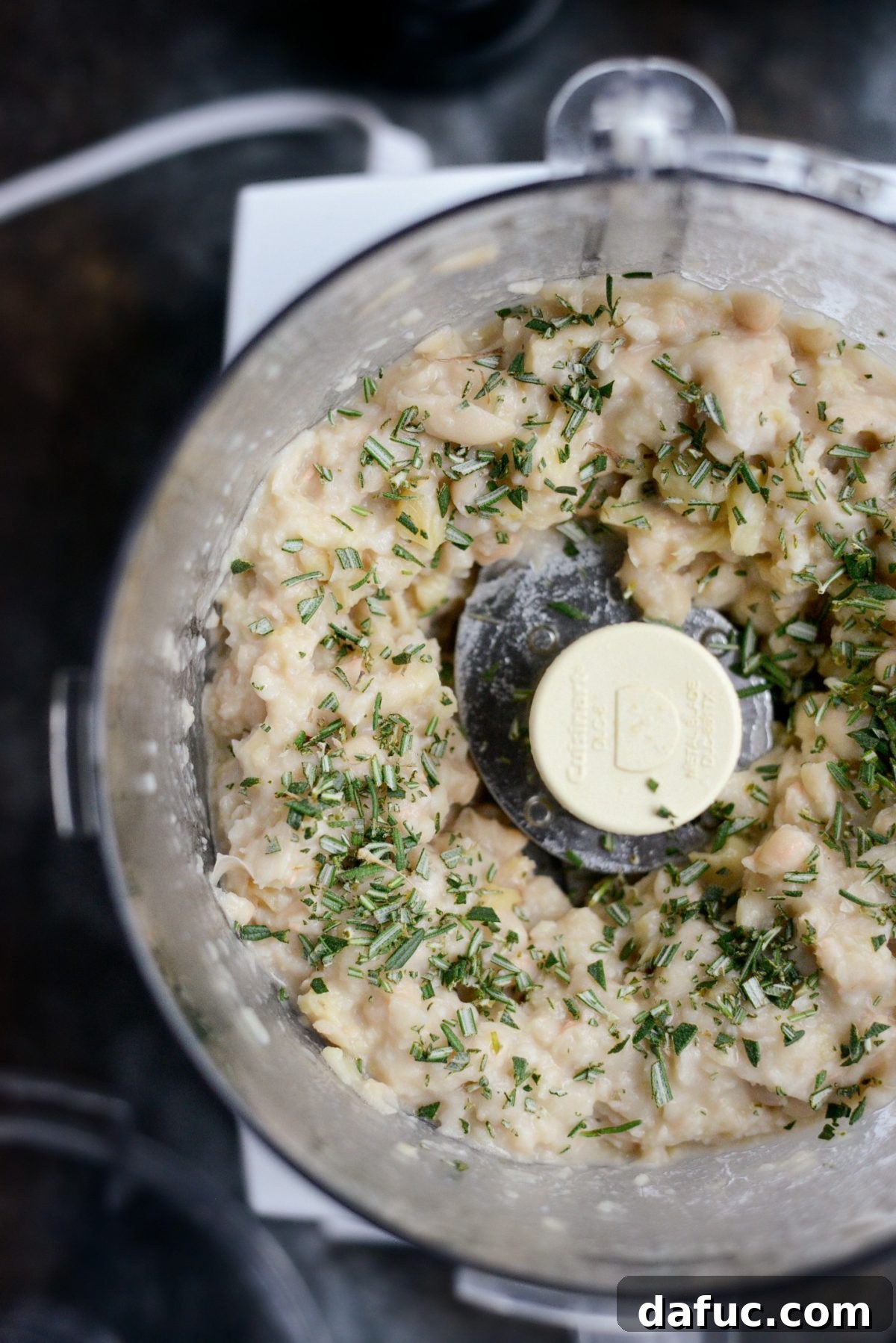 Pulsing the white bean dip in the food processor and adding freshly chopped rosemary.