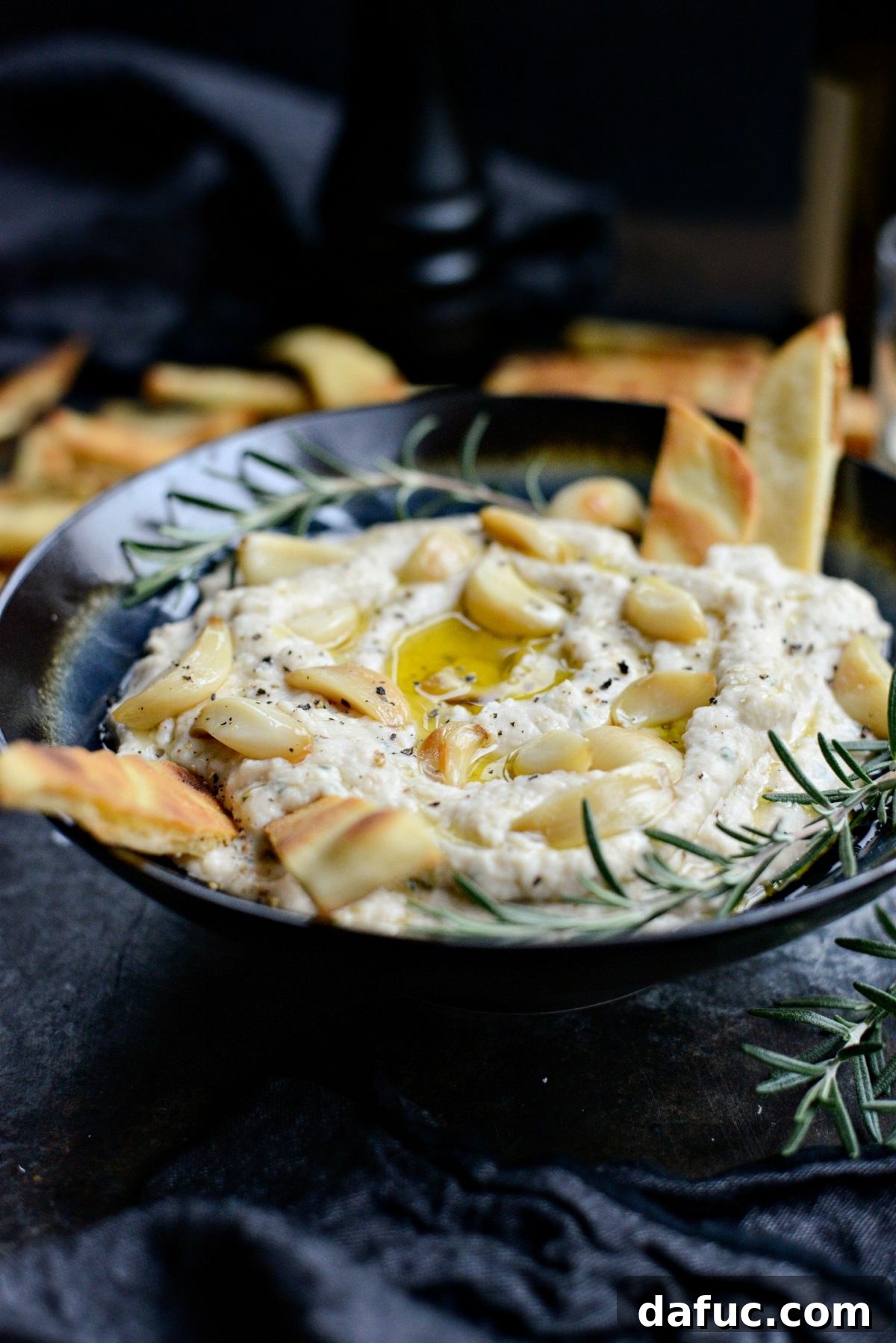 A festive spread featuring the Roasted Garlic and Rosemary White Bean Dip, perfect for holiday entertaining.