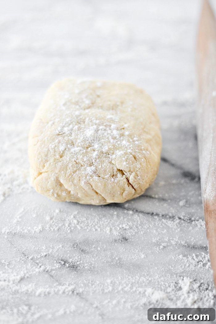 Effortless Homemade Croissant Perfection 12 Placing dough on floured surface, dusting with flour