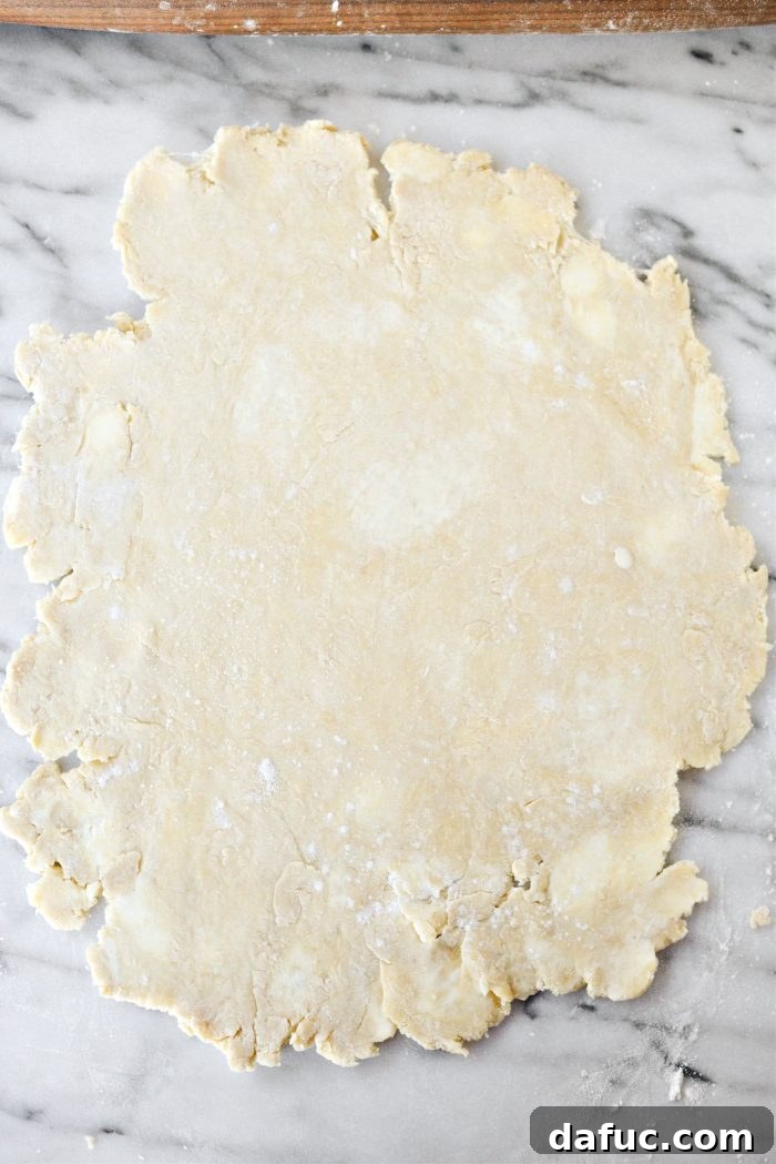 Effortless Homemade Croissant Perfection 13 Rolling out the croissant dough into a rectangle