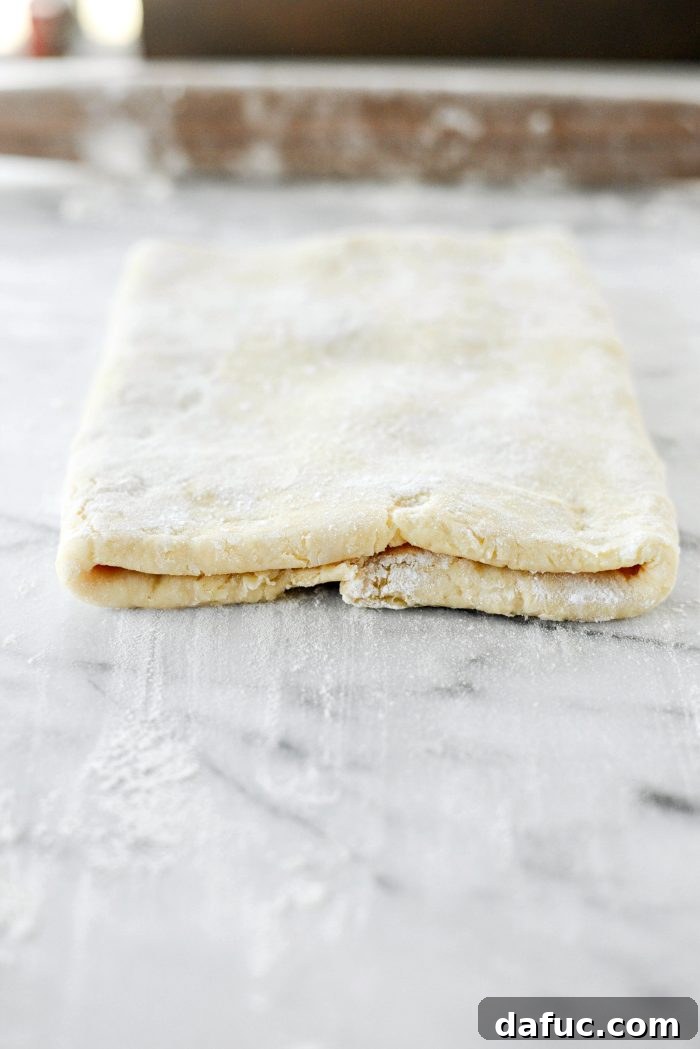 Effortless Homemade Croissant Perfection 16 Flipping the dough seam-side down