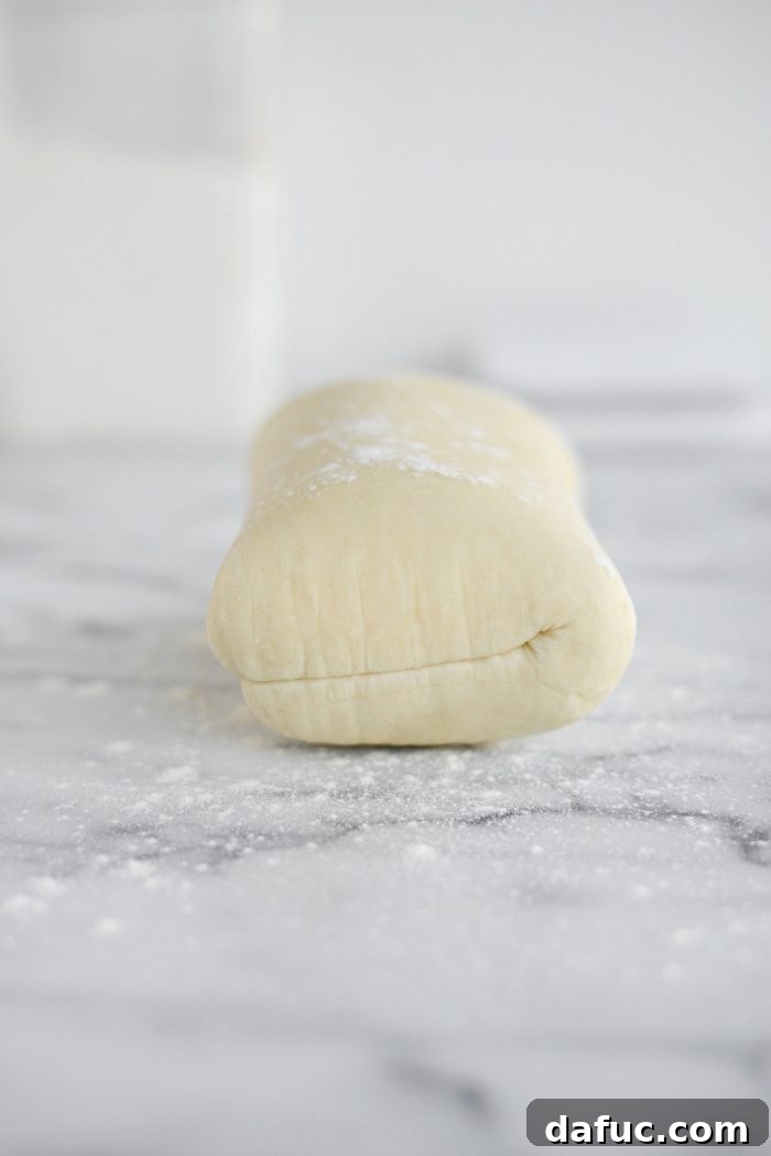 Effortless Homemade Croissant Perfection 18 Chilled dough on a lightly floured surface, ready for shaping