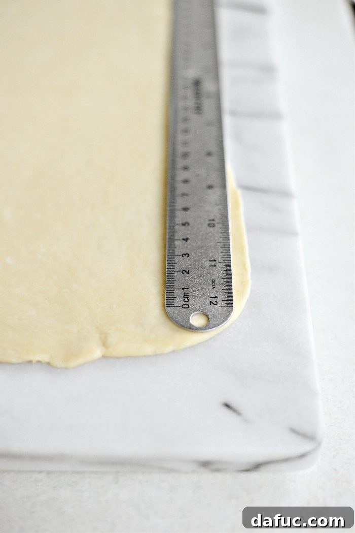 Effortless Homemade Croissant Perfection 19 Rolling out dough to a 10x16 inch rectangle and measuring
