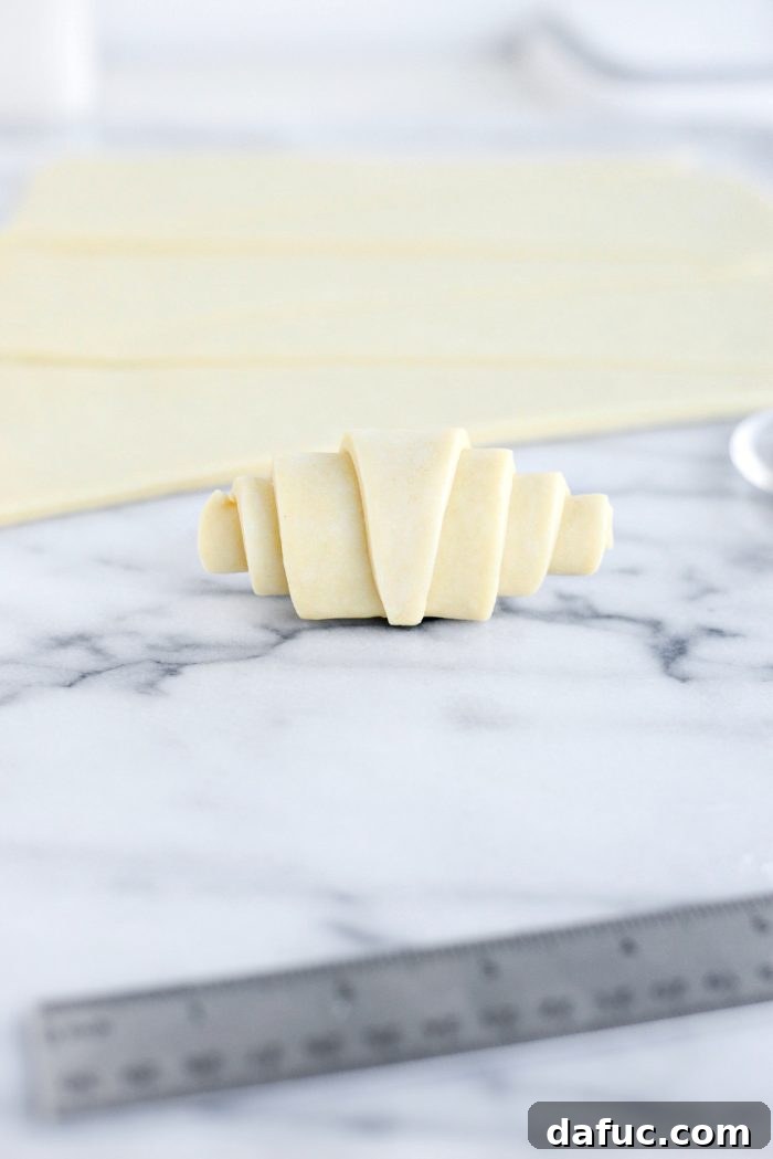 Effortless Homemade Croissant Perfection 23 Finished rolled croissant dough, ready for proofing