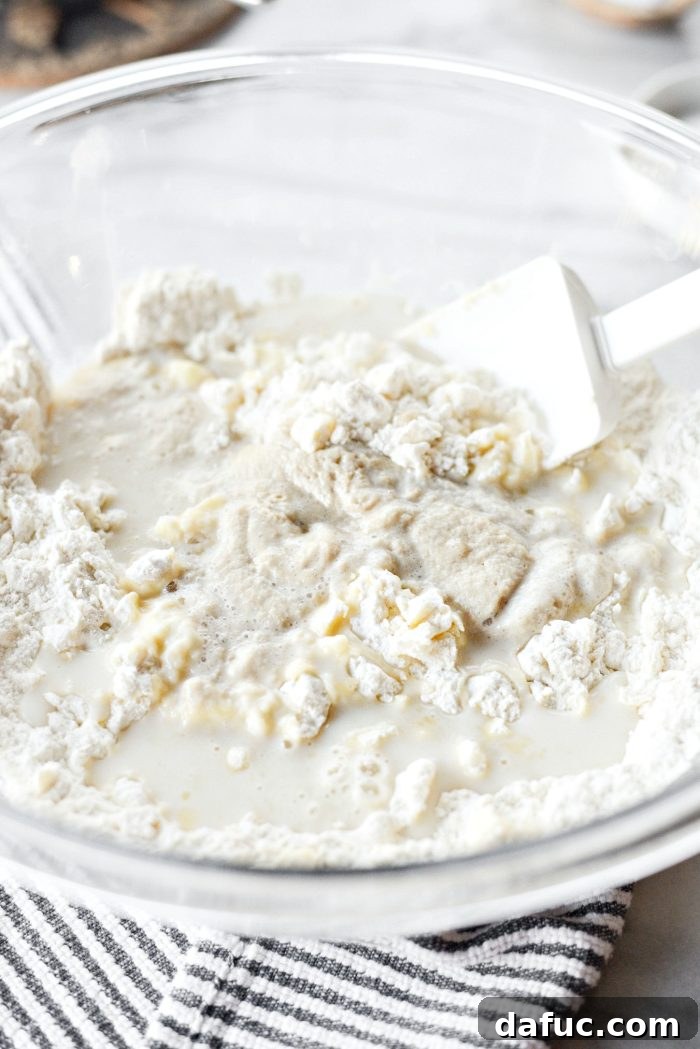 Effortless Homemade Croissant Perfection 10 Stirring to combine dough for easy homemade croissants