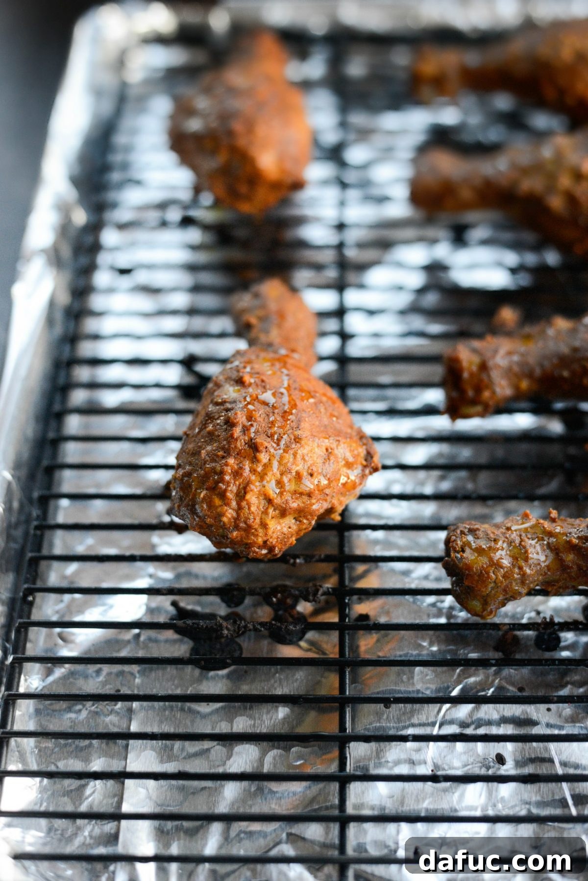 Final basting of oven tandoori chicken before broiling for char.