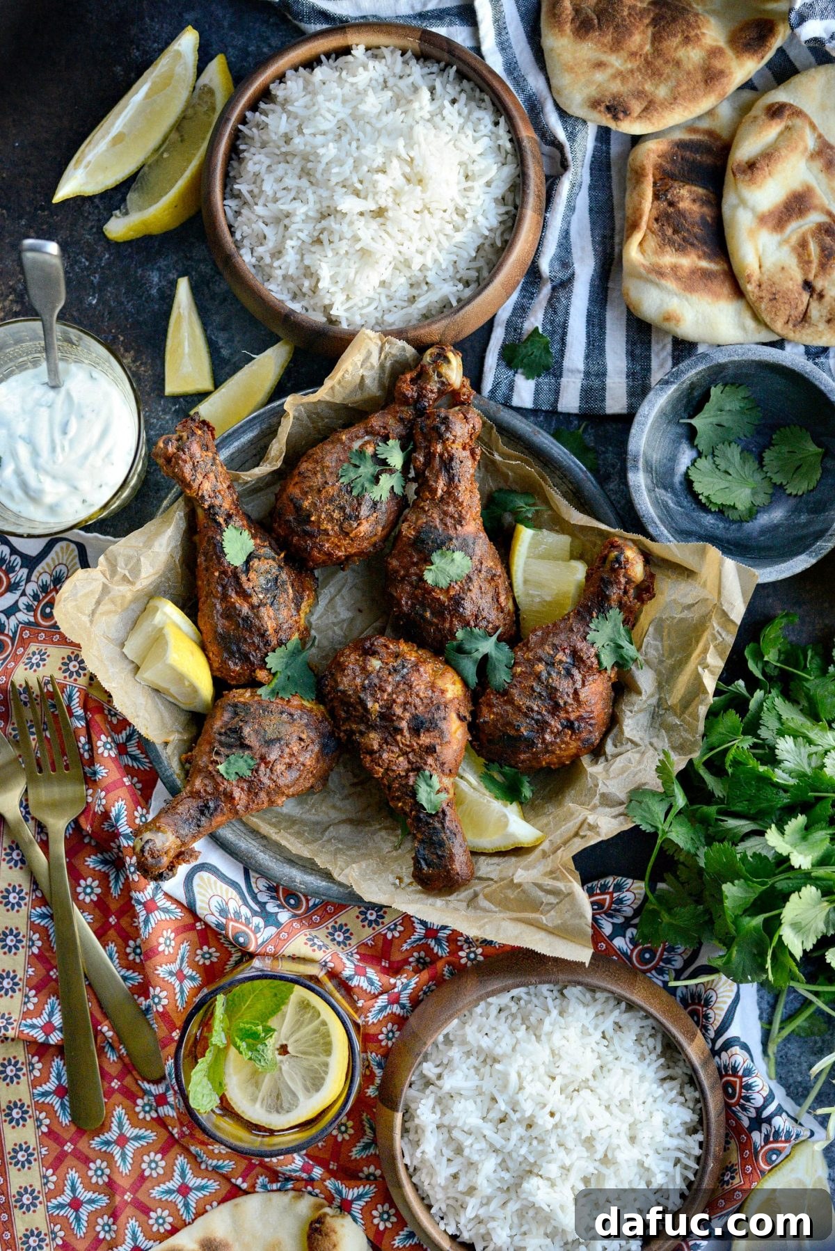 Close-up of golden-brown Oven Tandoori Chicken drumsticks on a baking rack.