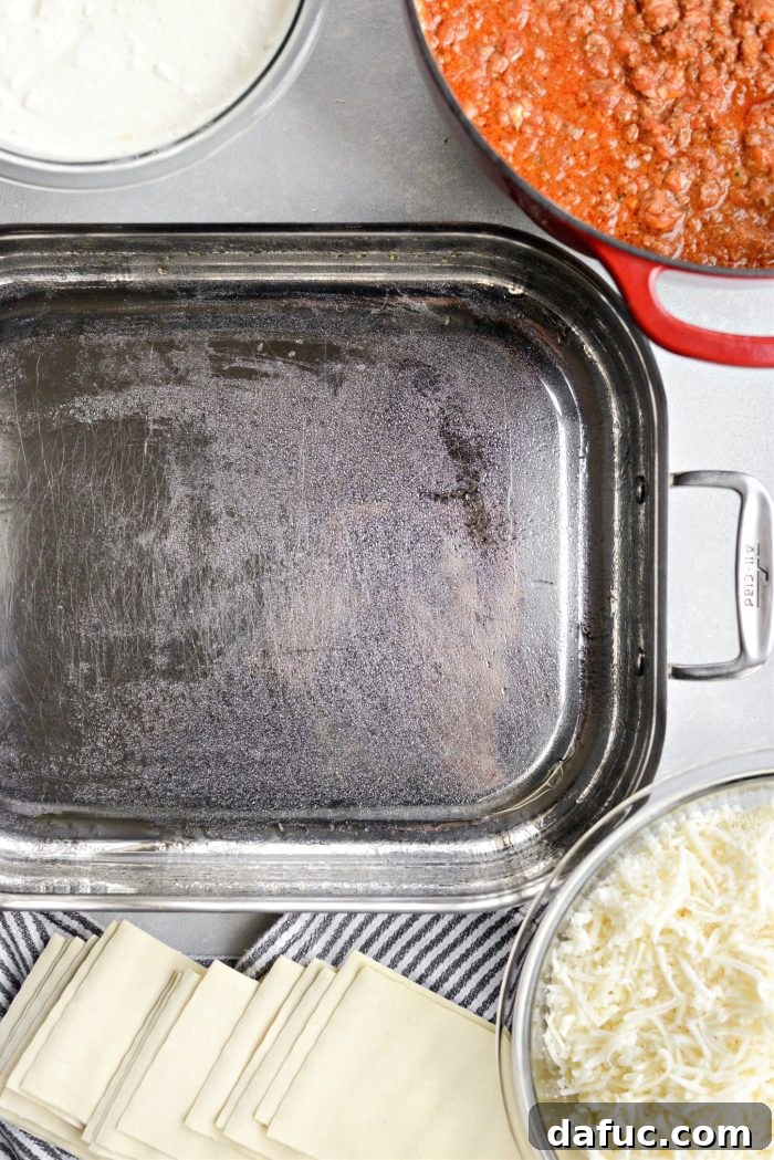 Lightly spraying a lasagna pan with olive oil