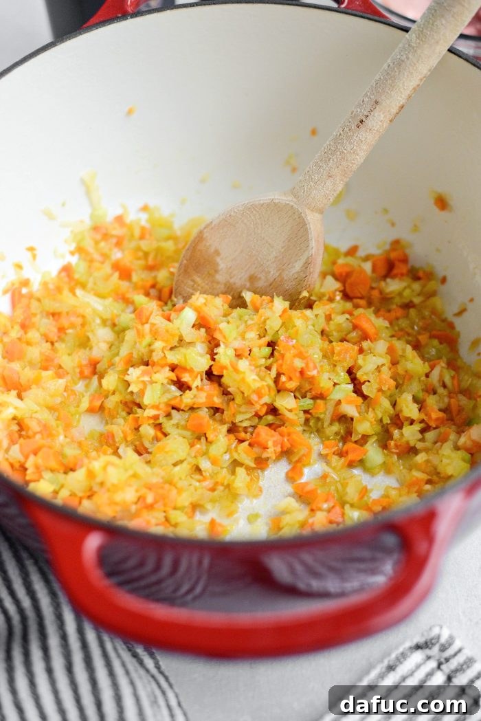 Stirring and sautéing vegetables in a Dutch oven until tender