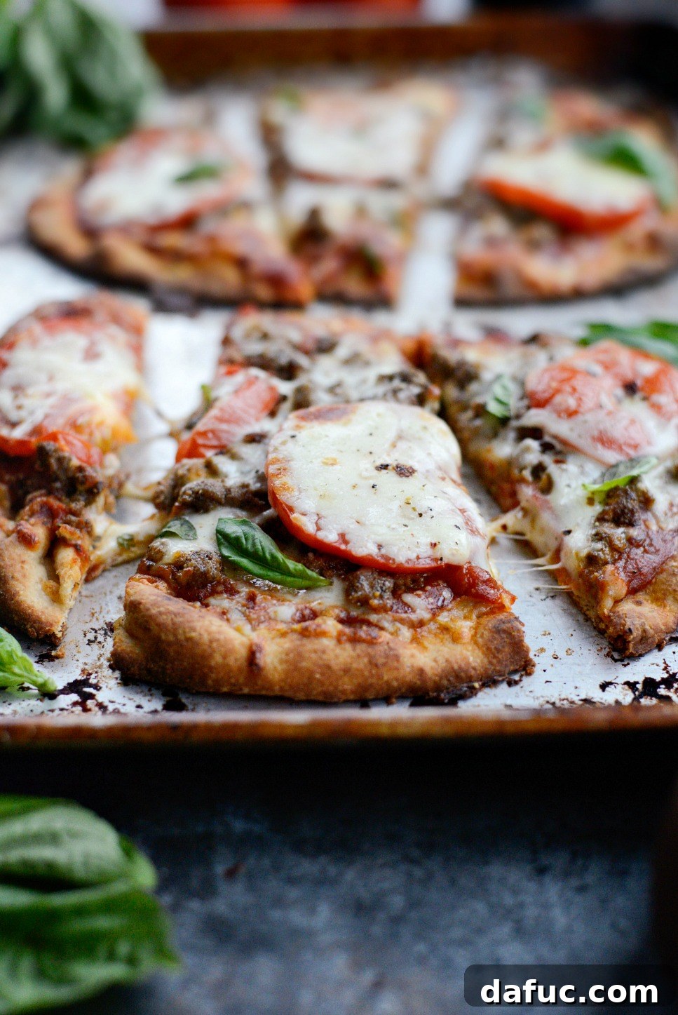 Levantine Lamb Margherita Pizza 2 A vibrant, close-up shot of a Lebanese Margherita Lamb Pizza, showcasing the crispy naan crust, melted mozzarella, spiced lamb, fresh tomato slices, and basil leaves.