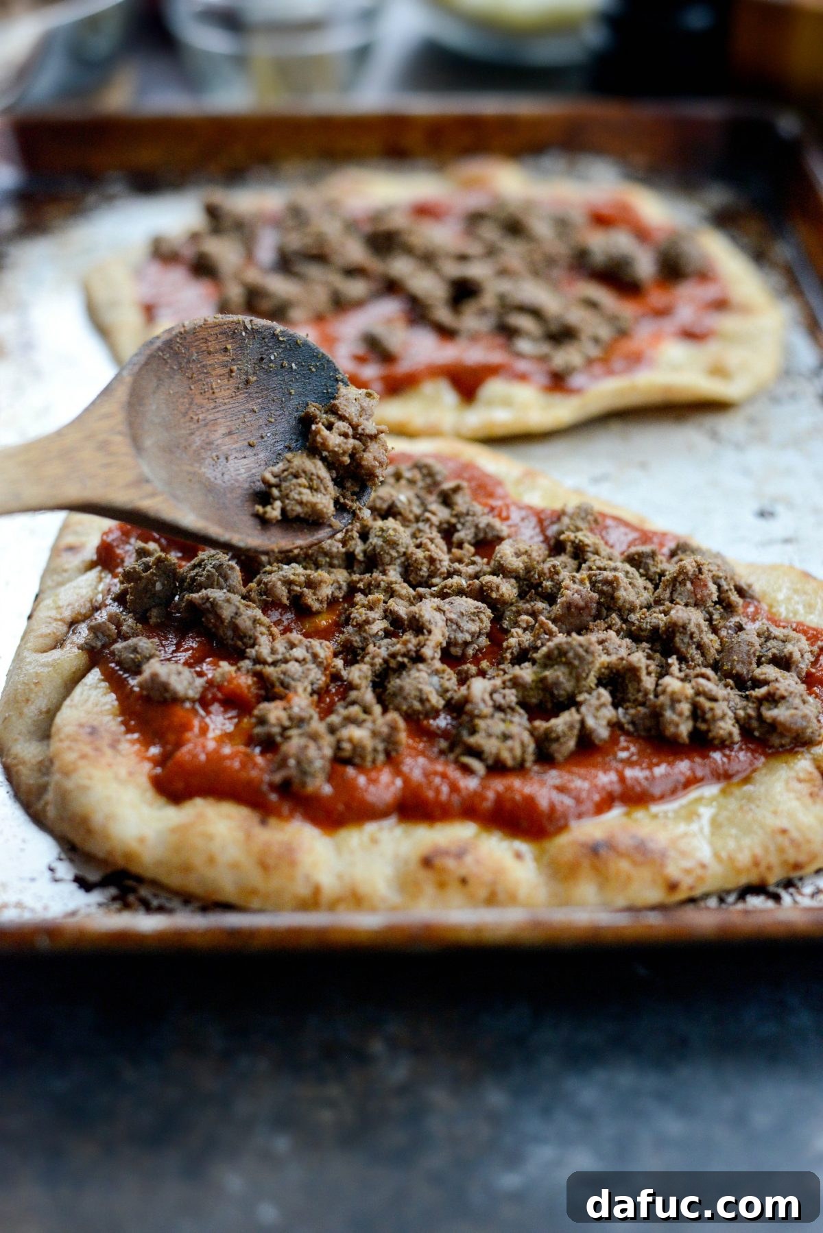 Levantine Lamb Margherita Pizza 11 The spiced ground lamb mixture being divided and spread over the marinara sauce on the naan.