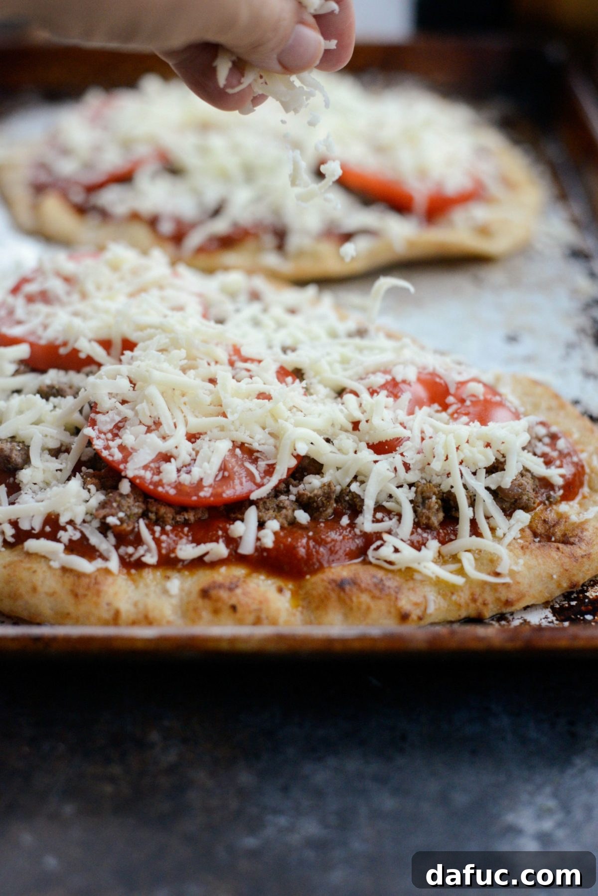 Levantine Lamb Margherita Pizza 13 Shredded mozzarella cheese sprinkled generously over the pizza toppings.