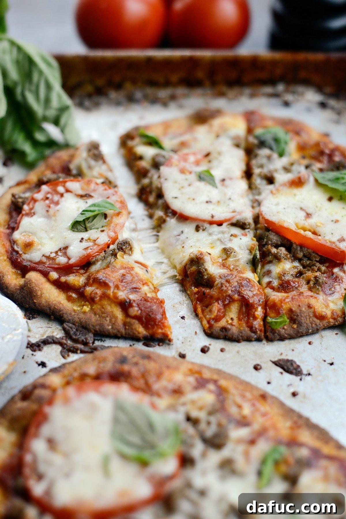 Levantine Lamb Margherita Pizza 16 A slice of Lebanese Margherita Lamb Pizza being pulled from the whole, showcasing the layers of toppings and the crispy crust.