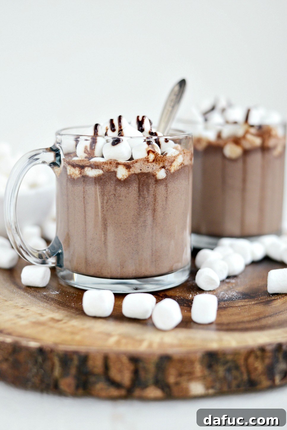 Mocha Magic 2 Espresso Hot Chocolate in a mug, topped with whipped cream and chocolate syrup, perfect for a cold winter day