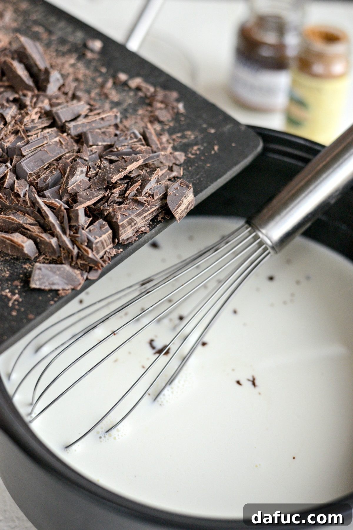 Mocha Magic 11 Chopped semi-sweet chocolate being added to the hot milk and cream mixture in the pot