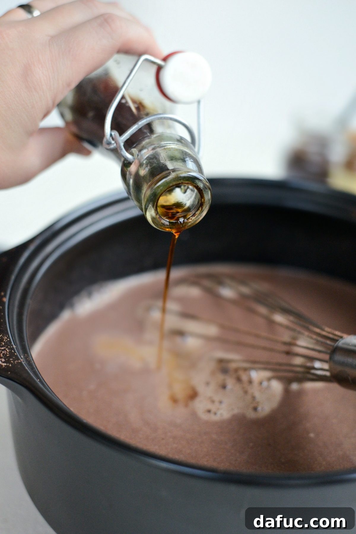 Mocha Magic 13 Pure vanilla extract being added to the espresso hot chocolate in the pot