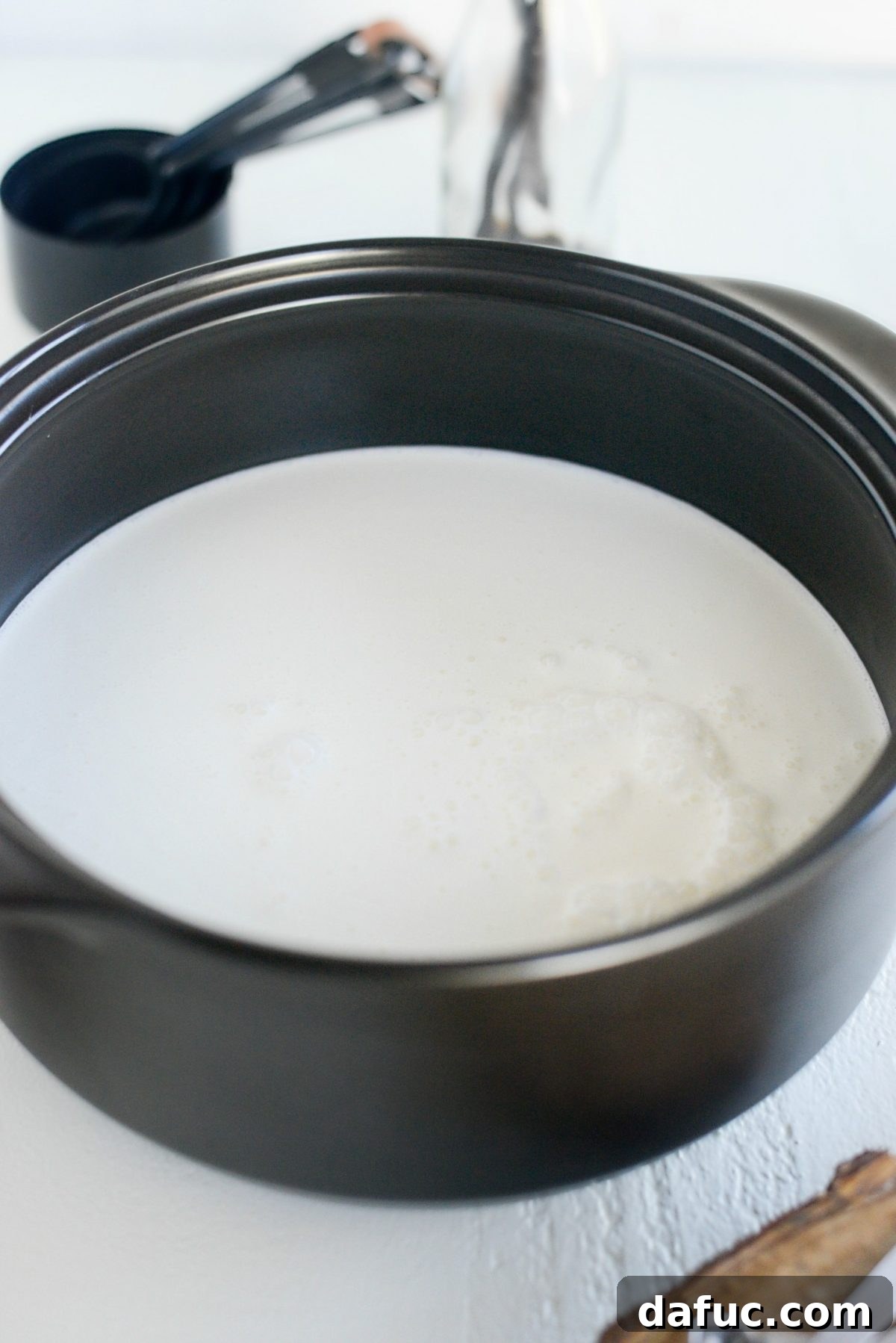 Mocha Magic 5 Whole milk and heavy cream being poured into a large pot or Dutch oven