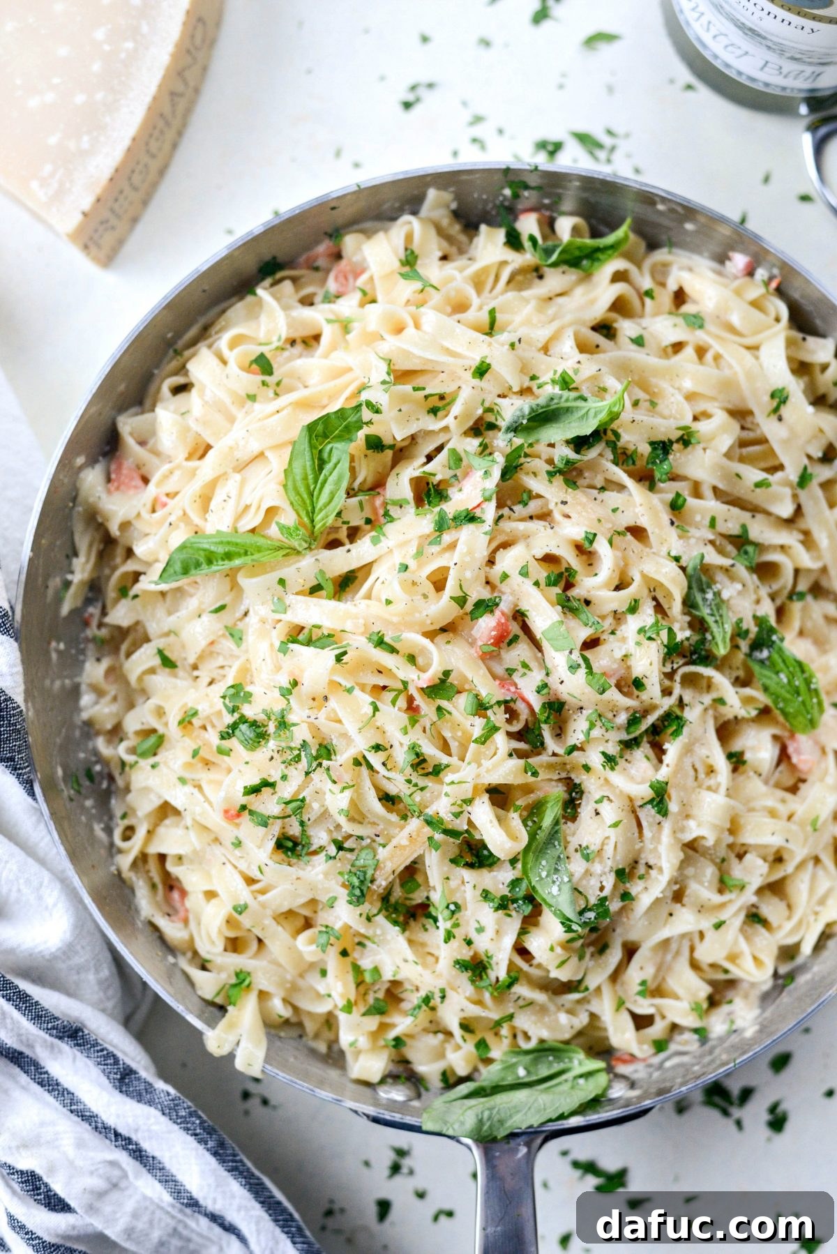A serving of Christmas Fettuccine in a pasta bowl, garnished with fresh herbs.
