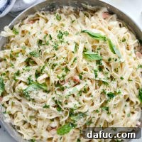 Christmas Fettuccine, a creamy pasta dish with red and green garnishes, perfect for the holidays.