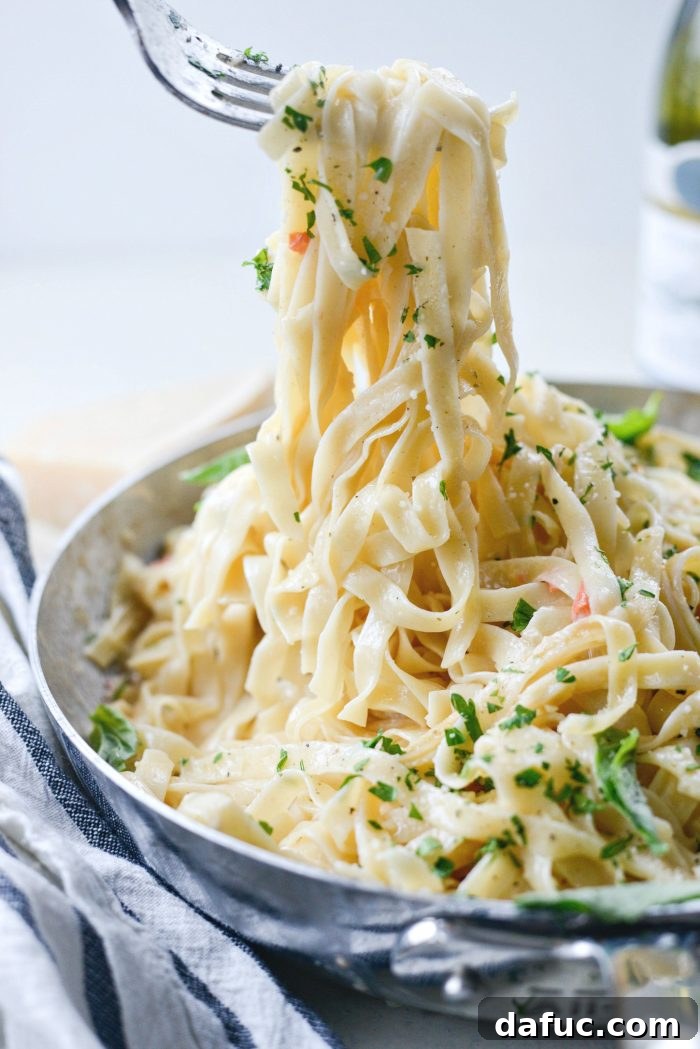 A close-up of the homemade Christmas Fettuccine, showcasing its creamy texture and fresh herbs.
