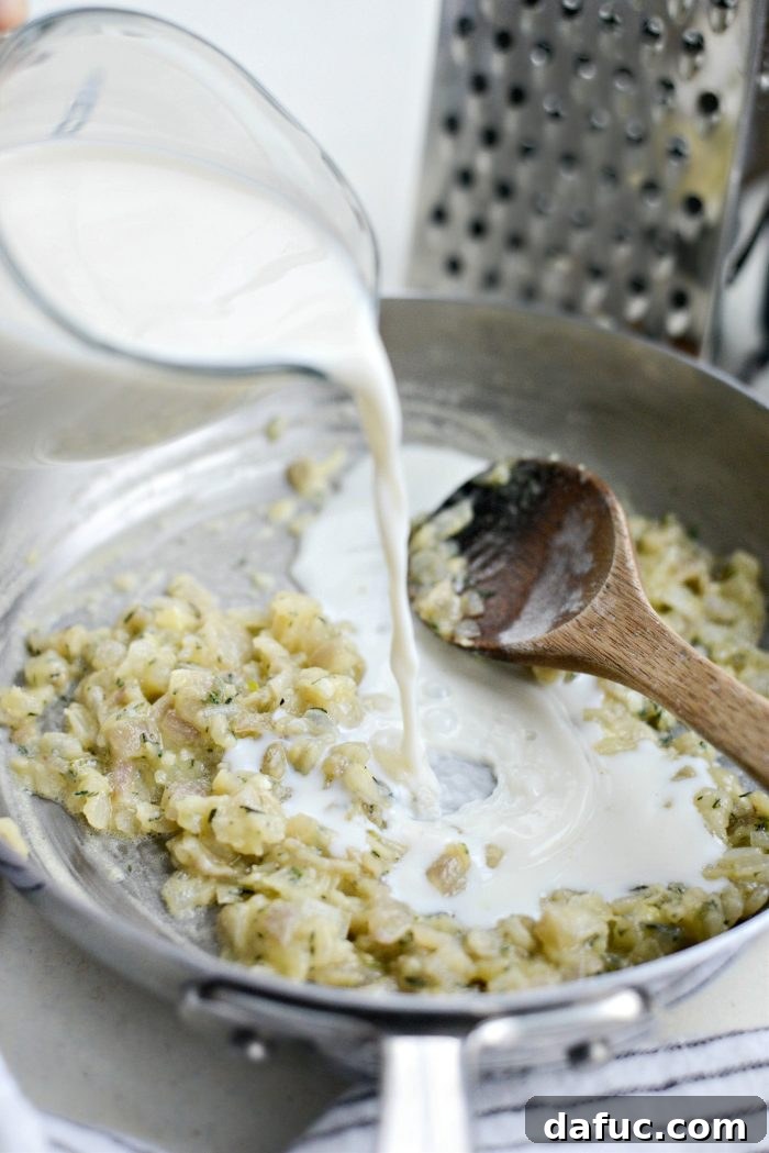 Gruyere Potato Gratin 11 Pouring whole milk into the skillet with the roux.