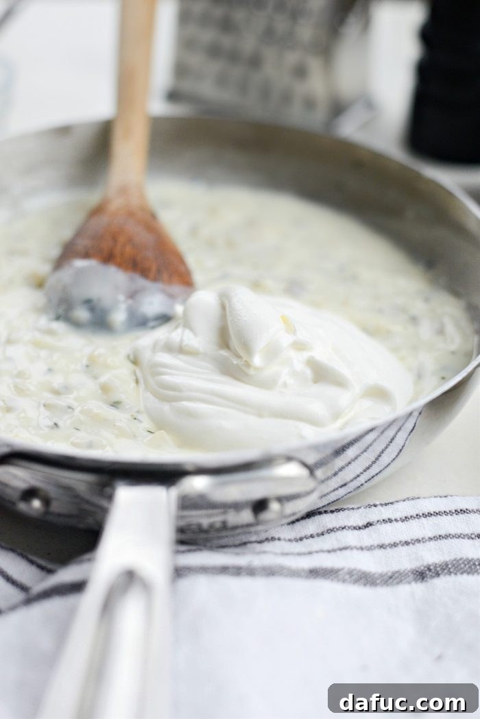 Gruyere Potato Gratin 13 Stirring sour cream into the thickened sauce.