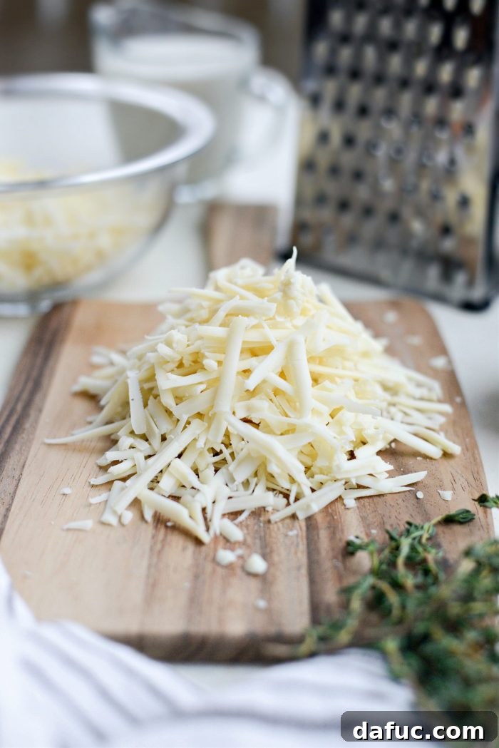 Gruyere Potato Gratin 7 Close-up of freshly grated Gruyere cheese in a bowl.