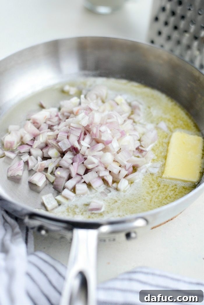 Gruyere Potato Gratin 8 Shallots sautéing in melted butter in a skillet.