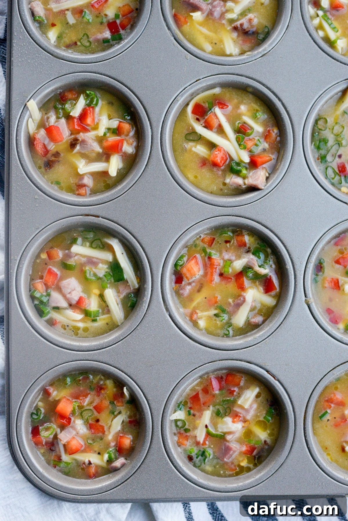 Muffin tin filled with frittata mixture