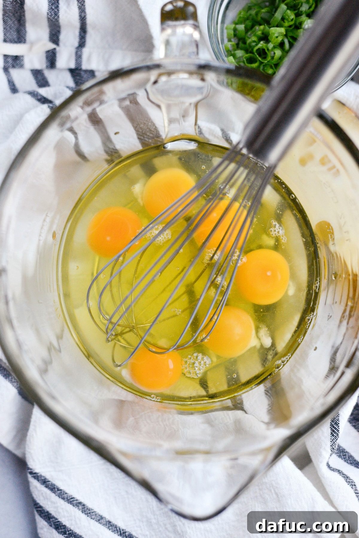 Cracking eggs into a mixing bowl
