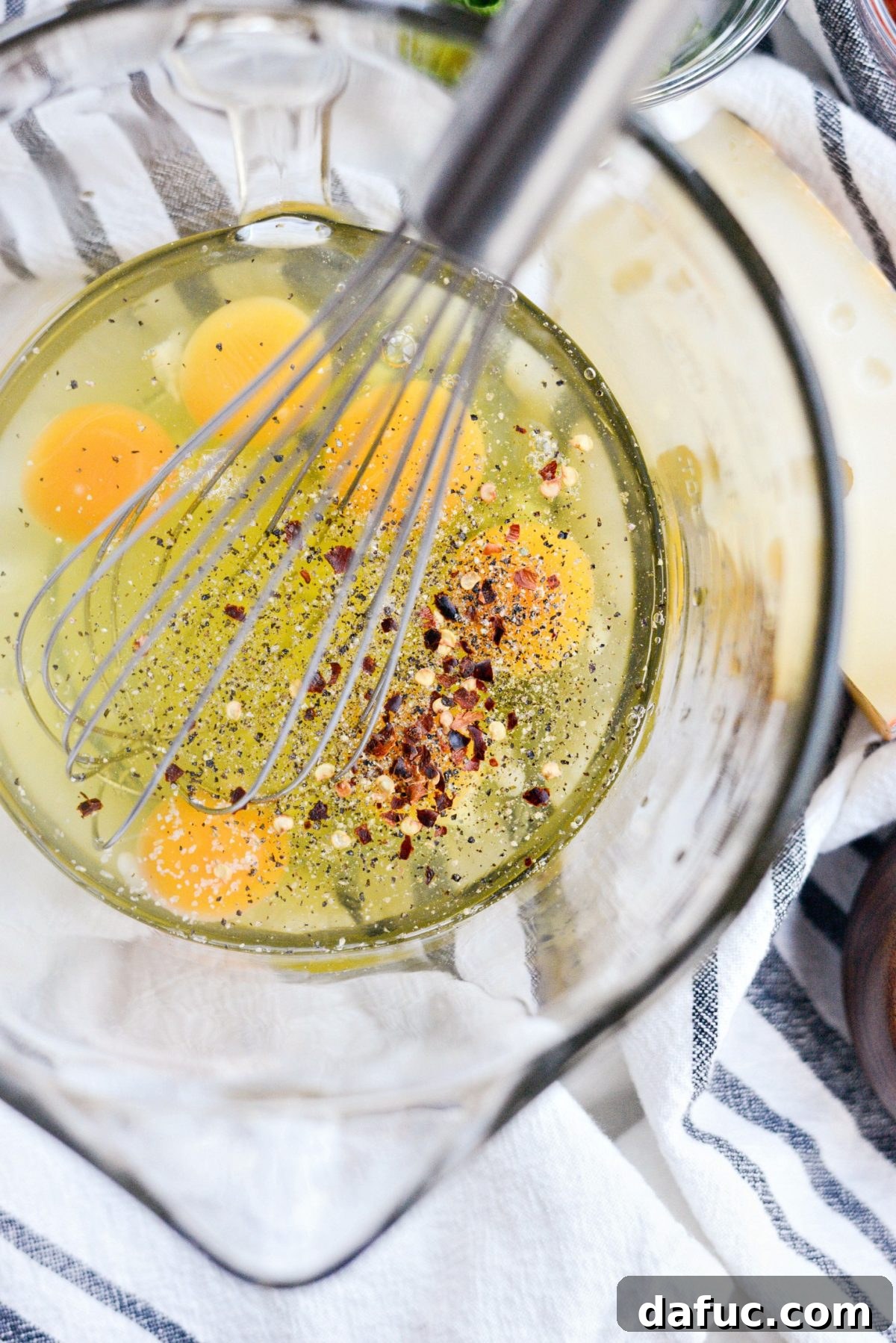 Adding black pepper and red pepper flakes to eggs