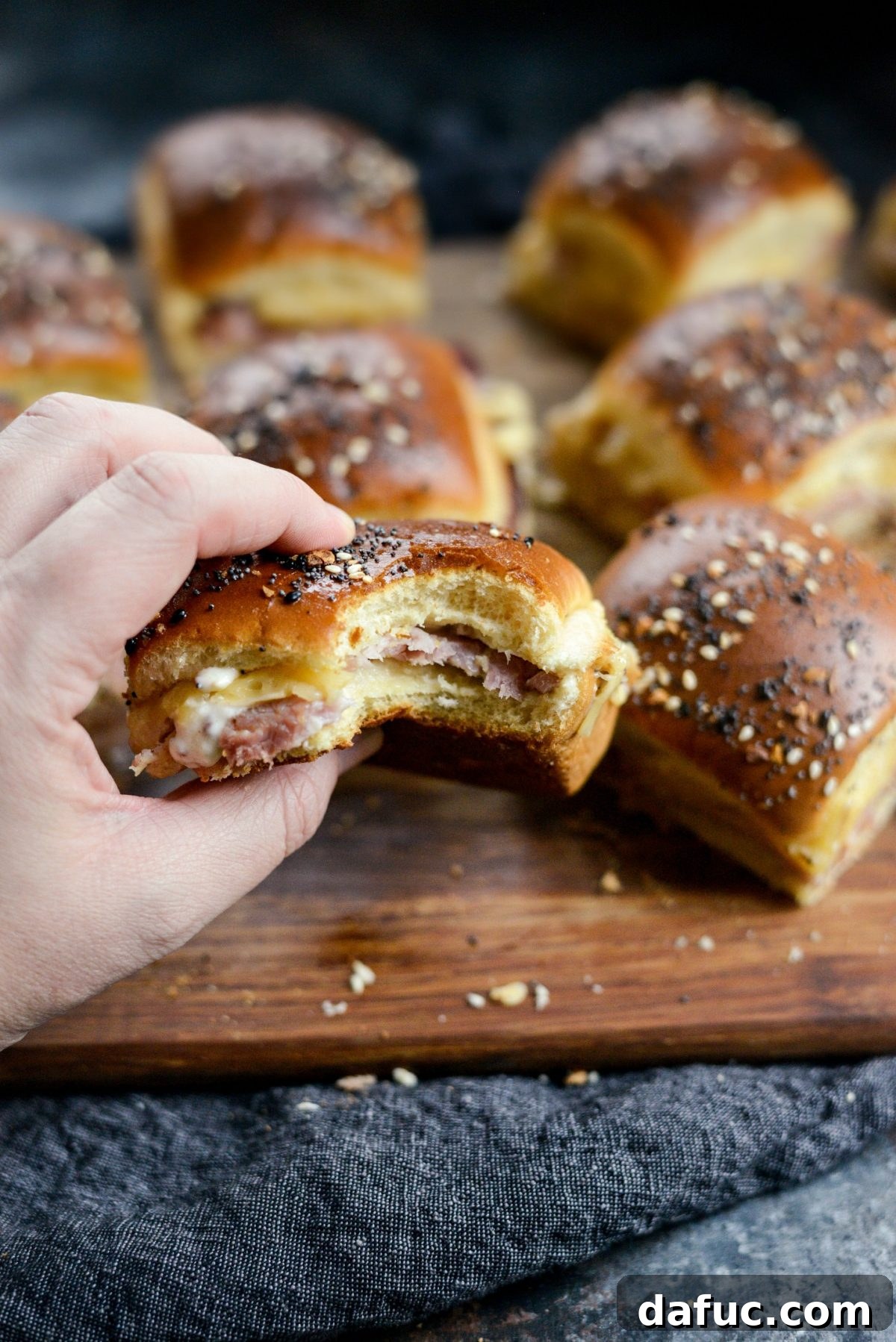 Gourmet Ham and Gouda Bites with Zesty Roasted Garlic Dijon 16 Closeup of a Ham and Gouda Party Sandwich, showing melty cheese and seasoning