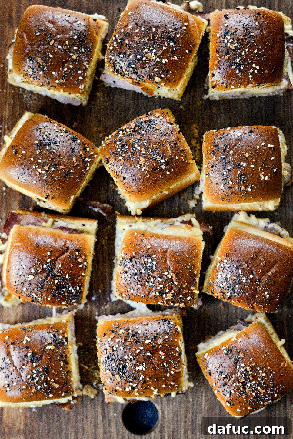 Gourmet Ham and Gouda Bites with Zesty Roasted Garlic Dijon 3 Festive Ham and Gouda Party Sandwiches on a platter